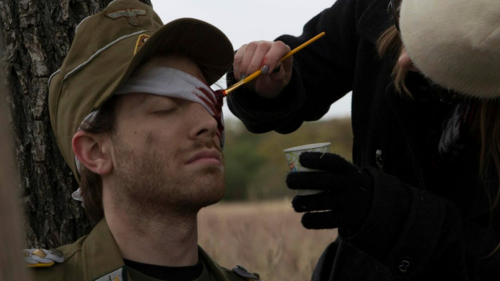 Applying bloody eye makeup