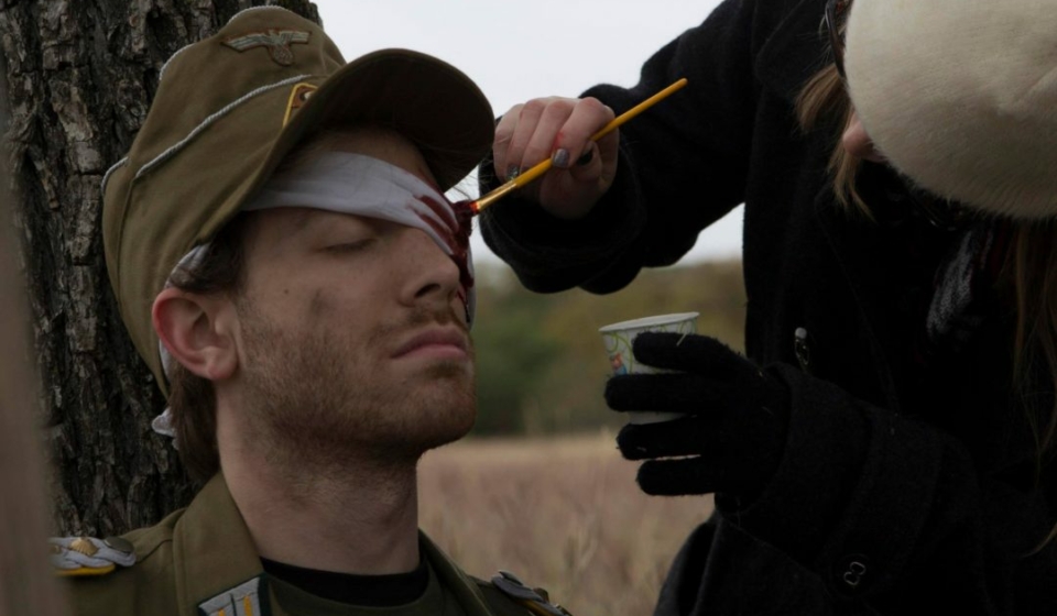 Applying bloody eye makeup