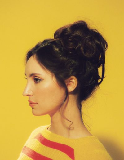 Model Profile, on Yellow Background in Stripped Yellow and red shirt